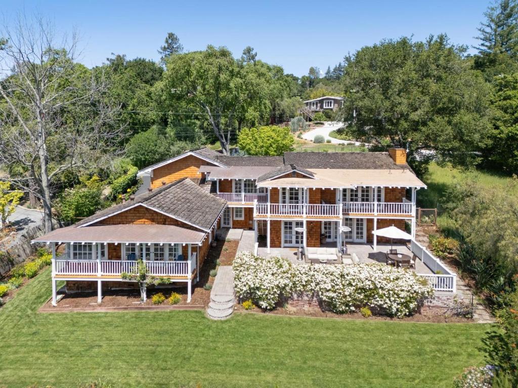 This home can be rented partially furnished. Whole-Home Transformation & Amazing Views This magical setting begins with a wine country-style garden entrance and continues out to sweeping western hill views and amazing privacy. A whole-home transformation created a luxurious indoor/outdoor space with designer finishes and an exceptionally bright and light ambiance. The floor plan is arranged with two distinct lower-level wings for the homes 4 bedrooms, connected by a vast rear terrace with inviting garden paths throughout the grounds of nearly one-half acre. The main living areas, catered by a stunning all-white gourmet kitchen, open to a covered deck for ultimate view enjoyment. A lower-level family room plus offices on each level round out the accommodations. There are 3.5 baths, each beautifully appointed in a selection of Carrara marble and glass tiles. Access to acclaimed Woodside Elementary School and proximity to miles of hiking trails add the finishing touch to this exceptional home.