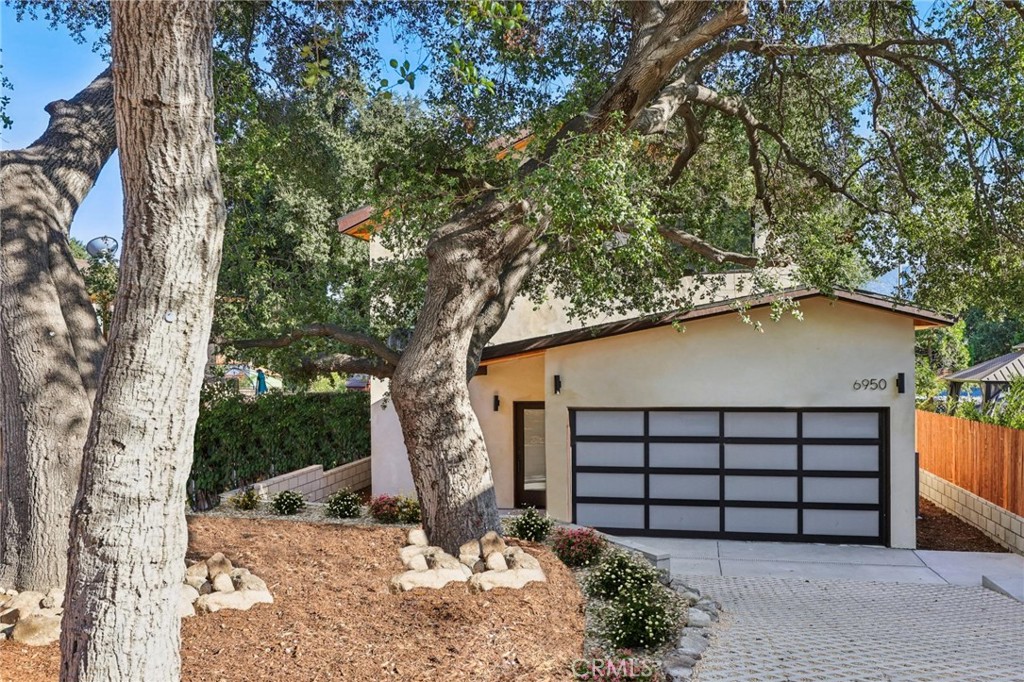 A brand-new construction in a gated green oasis, this never-lived-in home is a rare find in Tujunga, where new construction is almost unheard of. Thoughtfully designed and built from the ground up, this 3-bedroom, 3-bathroom residence blends modern comfort, refined luxury, and an unwavering sense of peace and retreat.
Every detail is brand new and under warranty, from the systems and appliances to the finishes and fixtures. The 1,620 sq. ft. interior is filled with natural light, enhanced by multiple skylights, and designed to impress. The gourmet kitchen features an induction cooktop, smart refrigerator, wall oven, microwave, wine fridge, and an elegant wet bar – perfect for entertaining. A dual-zone central HVAC system ensures year-round comfort.
The 6,225 sq. ft. lot is fully gated and professionally landscaped, with mature protected oak trees, lush greenery, a trellis-covered patio, and an automatic sliding driveway gate with LiftMaster motor, creating a true sense of privacy and tranquility.
Additional highlights include a whole-house fire sprinkler system, an invaluable safety feature in fire-prone Los Angeles, and integrated smart home features throughout. Enjoy low-cost, energy-efficient living with 8 fully paid-off solar panels (no lease or loan) and a brand-new 1,000-gallon fiberglass septic system with leach bed, designed for low maintenance with service needed only every 4.5 to 5 years.
Surrounded by elegant landscaping and tucked behind gates, this rare gem offers a lifestyle of serenity, security, and sophistication. With no other comparable new construction currently available in Tujunga, this one-of-a-kind home won’t last – make it yours before it’s gone!