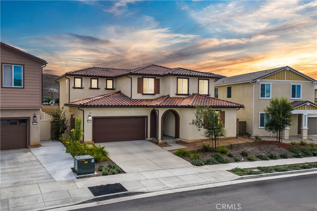 Discover the perfect blend of new construction luxury, custom upgrades, and modern design at 34184 Pink Place, an exceptional Plan 10 model home located in the highly sought after Viola at Siena community within the top-rated Temecula School District. This stunning two-story residence showcases an array of high-end finishes including luxury vinyl plank flooring throughout, plantation shutters on every window, and recessed lighting in each room and common areas, enhancing its bright and sophisticated ambiance. The gourmet kitchen is a chef’s dream, featuring pendant lighting, a stylish backsplash, a double oven, built-in microwave, stove, dishwasher, walk-in pantry, and a spacious center island perfect for both meal prep and entertaining. The home offers four bedrooms including a desirable downstairs bedroom and full bathroom with a soaking tub, separate shower, and dual sinks, plus a versatile loft and flex space ideal for a home office or playroom. The laundry room comes fully equipped with a sink and ample cabinetry for convenience. Step outside to enjoy the expansive California Room (covered outdoor living area) and a private backyard with no rear neighbors, perfect for relaxing or hosting gatherings. With no more homes being built in this community, this property is truly a rare opportunity to own a move-in-ready, designer-inspired home in one of the area’s most desirable neighborhoods. Schedule your private showing today and experience luxury living at its finest.