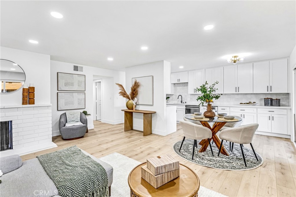 Nestled within the highly sought after Quail Meadows community, this meticulously renovated two-bedroom, two-bathroom condominium has it all! Showcasing a seamless integration of modern aesthetics and functional upgrades, evident in every aspect of its transformation, this unit certainly checks a lot boxes. The interior boasts elegant light oak laminate flooring, establishing a continuous and refined ambiance throughout the living areas. Energy-efficient dual-paned vinyl windows and doors further enhance comfort. The gourmet kitchen, a centerpiece of this residence, presents pristine white shaker cabinets equipped with soft-close, premium stainless-steel appliances and quartz countertops. A striking custom porcelain tile backsplash and contemporary black hardware elevate the culinary experience, while a conveniently located washer-dryer combination provides practical functionality. Both bedrooms feature en-suite bathrooms, creating private sanctuaries with mirrored closet doors that amplify the sense of space. The bathrooms have been meticulously reimagined, incorporating porcelain tile shower and bath enclosures, frameless shower doors, custom vanities, and harmonizing black hardware and fixtures. Climate control is effortlessly managed by central air and heating systems, ensuring year-round comfort. The unit overlooks the community pool and is just steps from the community’s tennis courts. This prime Tustin location is minutes from great dining and entertainment options, shopping and fantastic schools are not far. This is the one! Welcome Home!