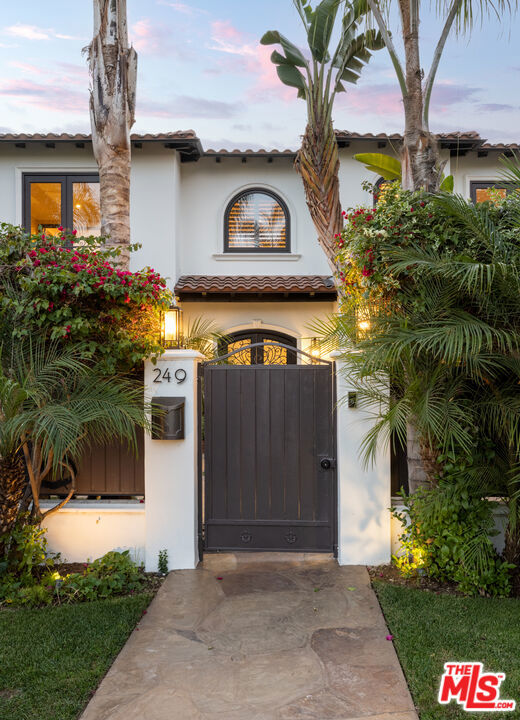 Located in one of Brentwood's best & most convenient locations, this is the largest home available in its area. 9,500 sqft laid out in an elegant, formal floorplan with public rooms on a grande scale and all bedrooms ensuite. Double entry doors open to a bright skylit foyer accented by soaring ceilings and a graceful spiral staircase. High ceilings create larger than life volume combined with an array of controlled lighting bringing warmth & coziness when needed. A formal living and family room open out to a spacious, sun-filled deck running the width of the house overlooking the pool and lush surrounding trees. An enormous cook's kitchen with massive island is the perfect space for entertaining and cooking with a huge formal dining space & sunny breakfast area steps away in either direction. The grand entry staircase leads you upstairs to all bedrooms; each en-suite with generous closets and baths. The primary has balconies in the bedroom & bath overlooking the rear yard and letting in air and light throughout the day. A sumptuous center spa tub, fireplace, double wide walk-in shower with his and her dressing rooms finish off a truly grand bath. Cozy spaces abound with a warm office off the foyer, & downstairs a comfy theater & bar area for relaxing. The downstairs floor opens out to the rear yard's pool, outdoor-kitchen and fire pit - the perfect indoor-outdoor space for entertaining. All floors made conveniently accessible by elevator & service stairway. The entire home is wired for sound throughout. Minutes from the best shopping and dining in Brentwood, this is an estate not to be missed.