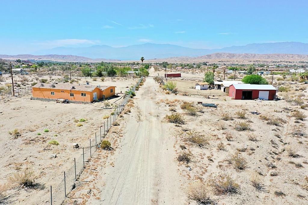MORE PICS COMING SOON...This is a great opportunity to create an estate. This beautifully located 5 acre property has million dollar views of the valley and the surrounding mountains and hills. Create an Airbnb CASHCOW or it has many other uses. (Verify uses with County). The property is divided by a service Road. The west side has its own electric and water meter. The East side has separate meters as well. The WEST SID portion has a Masonry home featuring 3 bedrooms, 2 baths; (3/.4 baths with showers only, NO bathtubs). A detached garage and a 30X40 Metal Structure, as well as a small detached room approx. 16x8 that can be used for storage or office. The EAST SIDE portion has TRIPLE WIDE manufactured home with 5 Bedrooms and 3 baths (1 full bath, the other 2 have showers only) on a permanent foundation with permits and professionally installed with plenty of supports underneath. This opportunity will not last long on the market as ranch properties are in demand. GRADED PROFESSIONALLY TO HELP MINIMIZE FLASH FLOODING. Even though the Coachella Valley gets very little rain, its GOoD to have this type of grading on rural properties near the hill areas.