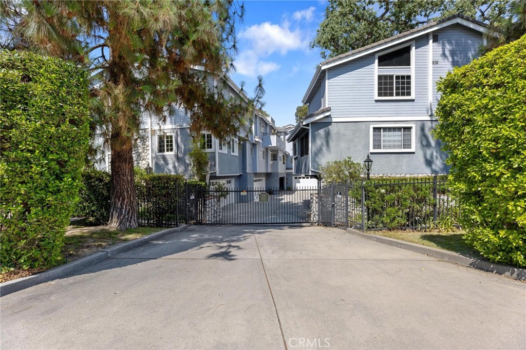 This stunning Woodland Hills townhome offers the perfect blend of comfort, style, and a serene natural setting with picturesque views of trees and the Calabasas creek. Thoughtfully priced for today’s market, this move-in ready residence features over 2,000 sq. ft. of living space, including 2 bedrooms and 2.5 bathrooms. Inside, soaring vaulted ceilings, hardwood floors, and a striking stone fireplace create a welcoming great room filled with natural light. A wall of windows frames with breathtaking views bring the outdoors in. The chef’s kitchen is beautifully appointed with stone countertops, stainless steel appliances, a wine fridge, and a cozy breakfast nook. The open layout flows seamlessly into the family, with both spaces opening directly to the balcony—ideal for relaxing or entertaining while enjoying the tranquil tree-lined views. Upstairs, the primary suite includes its own balcony, a home theater, a walk-in closet, and a sitting area. The designer bath features a soaking tub and separate shower. The second bedroom also offers an en-suite bath with dual sinks and a spacious shower. Additional highlights include upgraded dual-pane windows and balcony doors, a 2-car garage with epoxy flooring, and abundant storage. The gated community has a total of six units and provides fantastic amenities, including a secured entry, pool, guest parking, and HOA fees include insurance, water, sewer, trash, and common area maintenance. Conveniently located just minutes from The Commons at Calabasas, markets, top dining restaurants, Old Town Calabasas, and the 101 freeway. The Sellers are also including an 85” Sony TV, washer, dryer, refrigerator, and wine fridge. Don’t miss the opportunity to experience luxury living surrounded by nature in this exceptional Woodland Hills townhome!