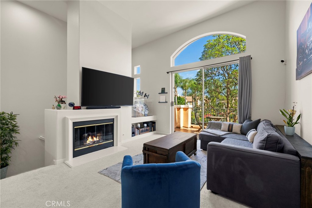 Welcome to this beautiful townhouse-style condo in the heart of Irvine, offering a spacious and thoughtfully designed floor plan. The inviting living room features a cozy gas fireplace and sliding glass doors that open to a private balcony, while the adjacent dining nook sits perfectly beside the updated kitchen with white cabinetry, quartz countertops, and stainless steel appliances. Upstairs, the expansive primary suite boasts its own private balcony, a large closet, and an en suite bathroom with dual sinks and a shower/tub combo. A generously sized second bedroom filled with natural light and a guest bathroom with a tub/shower combination provide comfort and convenience for family or guests. An attached two-car garage allows for easy access, while the community offers resort-style amenities including a sparkling pool, outdoor seating areas, an activity room, and two tennis courts. Ideally located, this home is just a few minutes from Crossroads Shopping Center with Target and many dining options, less than a 10-minute drive to UC Irvine, and close to The District at Tustin Legacy with even more shops, restaurants, and entertainment. Blending comfort, style, and convenience, this condo is the perfect place to call home.
