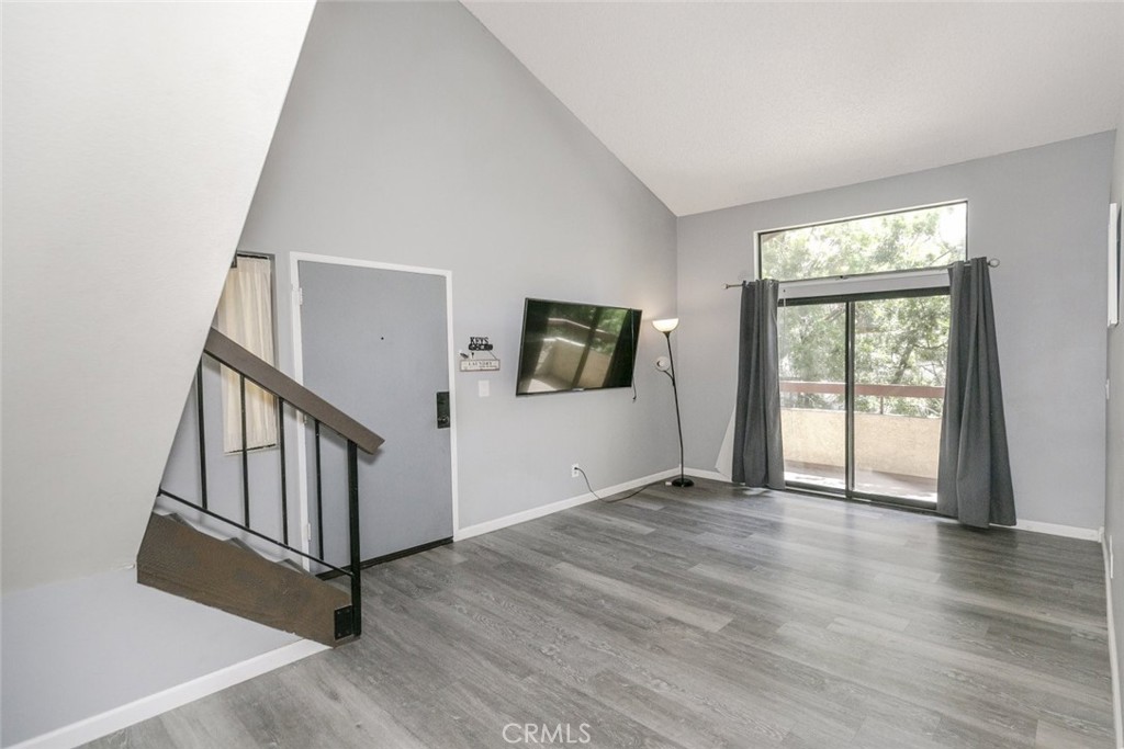 Now available in the sought-after community of Canyon Country, this beautifully updated 2-bedroom, 2-bathroom condo offers a stylish blend of comfort and functionality across 964 square feet of living space plus a nicely sized loft that adds valuable versatility as a home office, creative space, or guest retreat. As you enter, you are welcomed by soaring vaulted ceilings and abundant natural light that enhance the spacious open-concept layout. The living room serves as a warm gathering space, complete with sliding doors that lead to a serene private balcony surrounded by lush trees, perfect for enjoying your morning coffee or unwinding after a long day. The modern kitchen is a standout feature, equipped with sleek quartz countertops, custom cabinetry, stainless steel appliances, a gas range, and a chic tile backsplash. The adjacent dining area flows effortlessly from the kitchen, creating an ideal setting for everyday meals and entertaining guests. Both bedrooms are generously sized, with the primary suite offering an ensuite bath and ample closet space. The second bedroom provides flexibility for a guest room, home office, or personal gym. Additional features include updated bathrooms, in-unit laundry with a washer and dryer, and stylish vinyl plank flooring throughout most of the unit. Residents of this well-maintained complex enjoy resort-style amenities, including a sparkling pool, relaxing spa, and beautifully landscaped greenbelts. The HOA covers pool, spa or hot tub, maintenance of common grounds, trash, water, and security services. With a convenient location near schools, shopping, dining, and easy access to the 14 Freeway, this home offers the perfect combination of tranquility and accessibility.