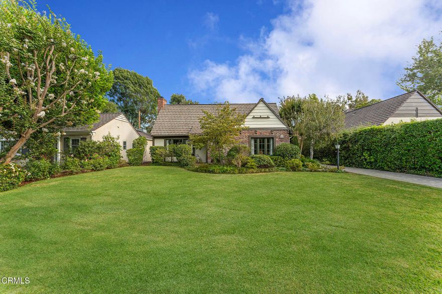 Nestled on a quiet street in San Marino's highly desirable Mission District, this English Cottage evokes the timeless charm of the countryside. With its steeply pitched roof, aged brick facade, and diamond-pane windows, the home radiates warmth and storybook appeal. A paver stone walkway meanders through lush flower beds to the inviting porch featuring arched wood beams that accent a vintage paneled door create a welcoming prelude to the home. Beyond the entry, built-in shelves and a petite view window lead into the dramatic living room, revealing soaring vaulted ceilings with exposed beams, gleaming hardwood floors, anchored by a striking stone fireplace with raised hearth and rustic wood mantel. A French door opens to the side patio, blending indoor and outdoor living. The formal dining room, illuminated by an opaque glass chandelier and abundant natural light, opens to the sunny breakfast room featuring a wrought-iron chandelier adorned with hand-painted ceramic accents, walls of cabinetry, a convenient prep sink, and a tiled serving counter that connects seamlessly to the kitchen--perfect for casual meals or morning coffee. The functional kitchen is appointed with tiled countertop, matching backsplash, and custom cabinetry. A versatile mudroom with laundry and an adjoining three-quarter bath adds everyday convenience, while a side door opens to the paver driveway that leads to the detached garage. A central hallway leads to the home's private quarters, where one bedroom features a walk-in closet and French doors to the side patio. At the end of the hall, a flexible primary suite can be closed off for added privacy and offers double closets, tranquil views of the backyard, and a primary bath with dual sinks. A third bedroom doubles as an office or den, enhanced by built-in bookcases and French doors that open to a wisteria-draped pergola--an enchanting setting for dining al fresco. The private backyard unfolds as an oasis of relaxation and leisure, with a sparkling pool surrounded by lush hedges and mature trees, offering the perfect retreat for lounging by the water or gathering with friends on warm evenings. Combining classic English charm with the best of California living, this quintessential cottage is truly your home sweet home!