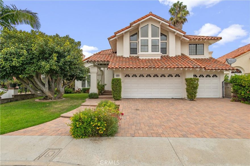 Welcome to 22201 Wayside, a beautifully updated home in the guard-gated community of Canyon Crest Estates. Freshly painted throughout with brand new wood flooring, this 4 bedroom plus bonus room, 3 bathroom residence offers approx. 3,434 sq. ft. of living space with a 3-car garage. The dramatic curved staircase entry leads to formal living and dining rooms and a family room with brick fireplace and built-ins. The gourmet kitchen features a large center island, granite countertops, refrigerator, and custom cabinetry. French doors open to a private backyard with paver hardscape and water fountain. The primary suite offers dual vanities, soaking tub, natural stone finishes, and a private balcony with panoramic views of Lake Mission Viejo, city lights, and surrounding hills. Community amenities include pools, spa, tennis, fitness center, clubhouse, and close distance to Lake Mission Viejo.