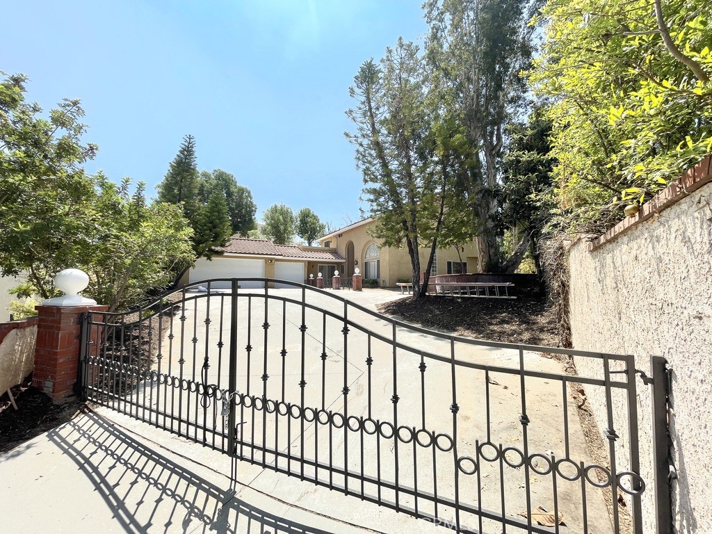 Welcome to your private retreat in Hacienda Heights! This spacious and well-maintained 4-bedroom, 3-bathroom home is nestled near the end of a quiet cul-de-sac on an expansive 13,139 sq ft flat lot. Enjoy the privacy of a gated entry and a semi-private driveway shared with just one neighbor. 3-car garage with space driveway for RV parking. Inside, you'll find 2,754 sq ft of thoughtfully designed living space featuring a formal living room, a separate family room with its own fireplace, and a versatile bonus room ideal for an office, media room, or guest space. The master suite offers a peaceful sanctuary with a fireplace, granite bathroom counters, a full soaking tub and shower, and a spacious walk-in closet. Recent upgrades include newly refinished vinyl flooring on the first floor and brand-new carpeting on the second floor. Upstairs, one of the bedrooms features a private balcony with picturesque views of the city and mountains.Step outside to an entertainer’s flat backyard with potential size for a sparkling pool, generous patio space, and ample room for a potential ADU. —perfect for extended family or rental income.