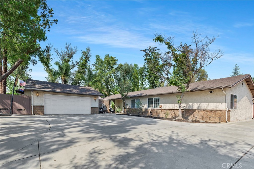 Private Woodcrest Retreat with Room to Roam
Set behind a gated entrance, this upgraded 4-bed, 2-bath single-story home sits on over half an acre in Riverside’s sought-after Woodcrest neighborhood. From the moment you drive up the long, tree-lined driveway, you’ll feel the privacy and peace this property offers.
Inside, a bright open layout is enhanced by new noise-reducing windows, crown molding, upgraded flooring, and recessed lighting. The chef’s kitchen is a standout with granite counters, white shaker cabinets, stainless steel appliances, and a peninsula that comfortably seats six perfect for casual meals or entertaining. The spacious primary suite includes a large closet and updated bath, while three additional bedrooms provide flexibility for guests, family, or a home office.
Outdoors, mature trees create a serene backdrop for a lush lawn, covered patio with TV hookup, and plenty of space for gatherings, RV parking, or even horses. The detached garage includes an extra 6' x 20' storage room, and the long driveway offers ample parking for multiple vehicles.
This is the perfect blend of privacy, function, and style. Ready to welcome its next owner.