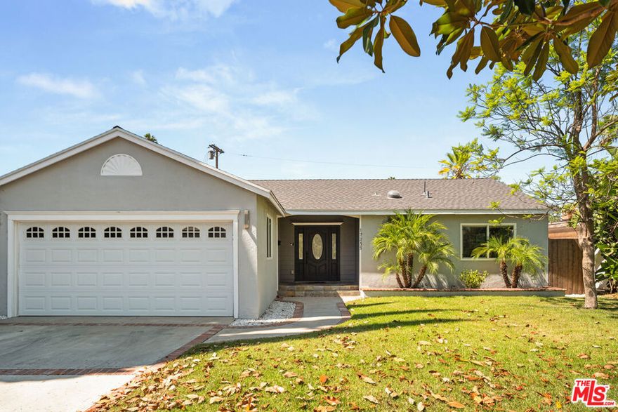 A True Balboa Park Charmer. This 3 bedroom home is a rare find, blending timeless charm with modern comfort. Situated on a peaceful street with beautiful curb appeal, it's just a short walk to Balboa Park's tennis courts and expansive green spaces. The light filled living room, enhanced by skylights, features a cozy fireplace, while the formal dining area offers an elegant space for gatherings. The chef's kitchen is a standout with custom cabinetry, quartz countertops, a spacious island, and a designer backsplash. The primary suite is larger than most in the neighborhood, thoughtfully created by combining two bedrooms into one expansive retreat, complete with a private full bathroom. Seamless indoor-outdoor living awaits with a covered patio, built-in BBQ, and firepit, perfect for entertaining. Additional highlights include double, pane windows and an attached 2-car garage.Don't miss the chance to own this charming and unique home in one of Encino's most desirable locations