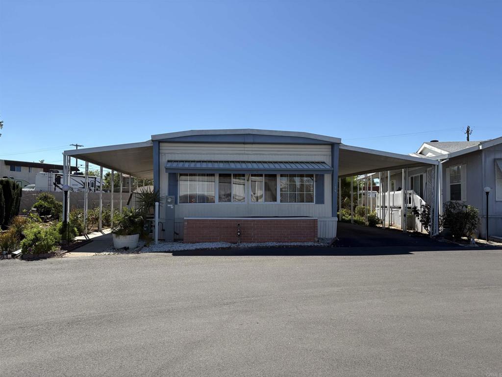 SENIOR COMMUNITY! $1,100 lot rent. No property tax = big savings to you! Nestled in the heart of the city of El Cajon, this stunning home is situated in one of the largest lots of a well-managed and well-maintained senior community. With no neighbors behind this beautiful home, you enjoy privacy and tranquility. This jewel of a home features 2 spacious bedrooms designed to maximize natural light and comfort. The spacious floor plan offers a large living room, ideal for relaxation and/or entertaining. Luxury Vinyl Plank floors can be found throughout this home. The kitchen includes all appliances. Washer and dryer inside the home to make laundry shores very convenient. Main bedroom has an ensuite bathroom for privacy and convenience. Guest bedroom and bathroom. Large side yards have many lush plants and flowers creating a serene environment featuring an automatic irrigation system to make taking care of the garden easy. Guest parking is just a few steps away. El Cajon Valley MHP offers its residents a swimming pool for those hot days and a clubhouse equipped with a full kitchen, a library and a pool table. Residents can host their events in this well equipped clubhouse. AAB3594.