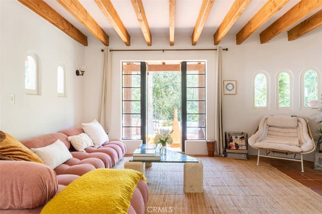 A Zen Oasis: Your Private Spanish Villa Retreat Awaits
———
Welcome to your own private sanctuary, a serene, light-filled Spanish villa-style home, nestled in the lush landscape of Topanga Canyon. Surrounded by towering palms, olive trees, and fragrant citrus, this one-of-a-kind property blends timeless architecture with peaceful, resort-style living.
——-
Step into a designer's dream, where high exposed wood-beamed ceilings, great natural light, and indoor/outdoor flow define every space. Nearly every room opens to the outdoors through elegant French doors, leading to a stunning Saltillo tile patio perfect for entertaining and al fresco dining. The property features a large grassy yard, ancient rose, fig, pomegranate, passion fruit, lime, and cara cara orange trees- a dream setting to grow, play, and connect with nature. The expansive gourmet kitchen, outfitted with state-of-the-art appliances and generous eat-in space, is ideal for intimate gatherings and culinary exploration. A romantic master suite offers its own private patio and a spa-like master bathroom, a tranquil retreat within the home. Enjoy world-class hiking in your own back yard or head to the beach, only 15 minutes away. With two separate entrances, a private road, and ample parking, the layout offers privacy and expansiveness.
Ideally located with convenient access to all Calabasas has to offer and top private and public schools within a 5-minute drive, yet feels like a world away. This serene and vibrant home is the perfect blend of California living and timeless tranquility. *Available furnished upon request