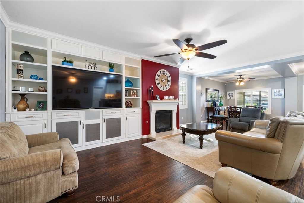 This 4B/2B SW gem with 2,177 sq ft is filled with thoughtful upgrades! Benefit from PAID solar giving you energy savings starting from moving day! Inside, you’ll find beautiful wood-look tile in the dining area, living rm & bdrms. Plantation shutters are thoughtfully installed throughout, adding both style & functionality to every room. A cozy living rm welcomes you with crown molding, a custom-built-in media center with shelving and inviting fireplace. The kitchen shines with sleek granite counters, a custom backsplash, and bar-top seating. Both bathrooms have been stylishly updated with granite counters, including a stunning custom tile shower in the hall bath. The spacious primary suite features a separate tub and shower, plus dual sinks and granite countertop. Outside, enjoy the low-maintenance backyard complete with artificial turf, all block walls for added privacy, fantastic curb appeal, and convenient RV parking. All this home needs is your personal touch.