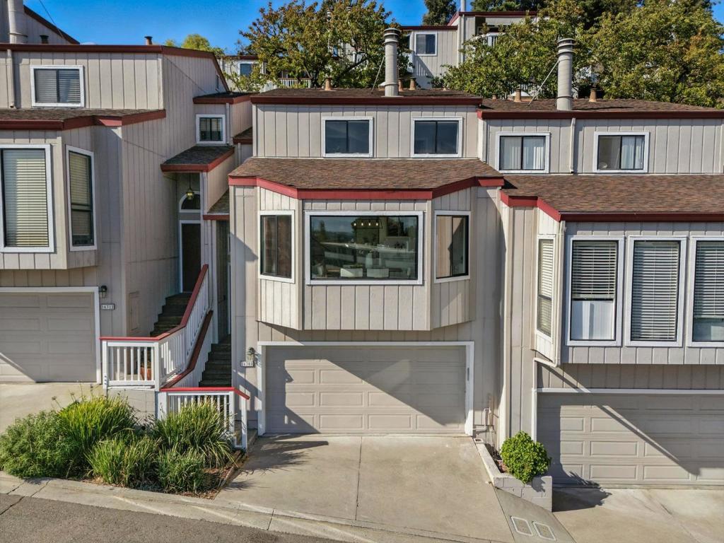Tucked away in the San Leandro hills, this home offers a blend of comfort and convenience. This 3 BD/3 BA townhome is thoughtfully laid out across two levels. The ground fl oor welcomes you with a light fi lled living/dining area framed by 180 degree views, an ideal setting for both quiet evenings and lively gatherings. The galley-style kitchen is designed for effi ciency and ease, featuring modern stainless steel appliances and an adjacent breakfast nook that opens to a peaceful inner patio. Also on this level, a full bathroom and versatile room, ideal for a home offi ce or guest bedroom. Upstairs, the primary suite serves as a private retreat, complete with a spacious closet and a beautifully remodeled ensuite with dual sinks and a soaking tub. A second upstairs bedroom offers its own ensuite and direct access to a balcony, creating a welcoming space for guests or family. Additional highlights include real hickory hardwood fl oors, two private balconies, a two car attached garage, and abundant storage throughout. Buyers are advised to verify availability and eligibility for enrollment or transfer within the Castro Valley School District or Yu Ming Charter School.
