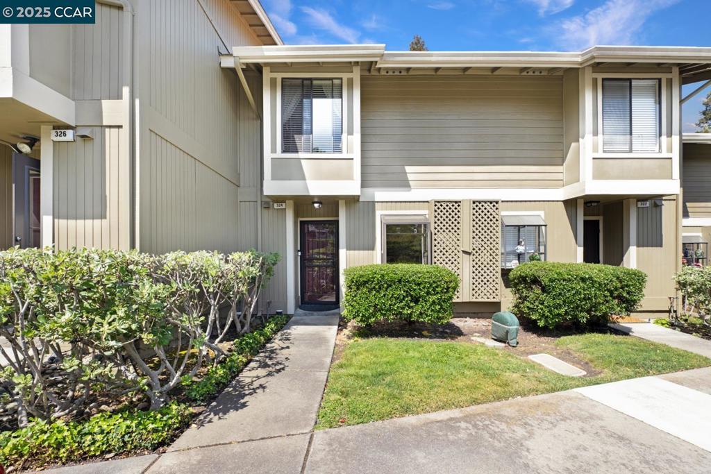 Welcome Home! Step into this beautifully updated two-story condo, featuring 2 bedrooms, 1.5 baths with 1085 sq ft of comfortable living space. Built in 1985, this gem is ready for you to move in. Enjoy the seamless flow from the kitchen to the dining area and living space, perfect for quiet evenings or entertaining. Kitchen features garden window, new cabinet doors & drawers w/ soft close and newer appliances (last 5 years). Living Room features tile fireplace and slider leading to private patio where you soak in the fresh air. Don't miss the 1/2 bath and the extra storage closet downstairs. Upstairs boasts a cozy guestroom w/ slider leading you to another balcony, a spacious primary suite and a convenient full bathroom located between the two. For added convenience, a stackable washer/dryer is conveniently situated next to the bathroom, making laundry a breeze. Condo also features newer flooring, newer water heater, and many more improvements. HOA includes water, trash, pool and two assigned parking spaces - 1 covered. Proximity to Holiday Highlands Park, shopping, freeway access and so much more!