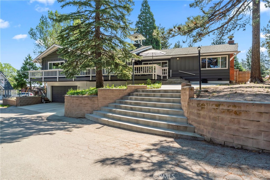 Welcome to your mountain sanctuary in the “Lower Rowco” neighborhood of Running Springs — a spacious and semi-updated single level home tucked away on a quiet street, offering the perfect blend of comfort, convenience, and natural beauty. Whether you’re seeking a full-time residence or a relaxing getaway, this property checks all the boxes. This home features a large garage with tons of storage, 2 fireplaces, new windows, fresh exterior paint, and recessed lighting that enhances the warm, inviting interior. A whole-house generator ensures year-round reliability, while the new cement driveway and stairs add durability and curb appeal. Enjoy morning coffee or evening gatherings on the new rear deck, surrounded by peaceful mountain scenery. The fenced side yard is perfect for pets, gardening, or a private outdoor retreat. Great Commuter Location just minutes from Snow Valley Ski Resort and Sky Park at Santas Village.