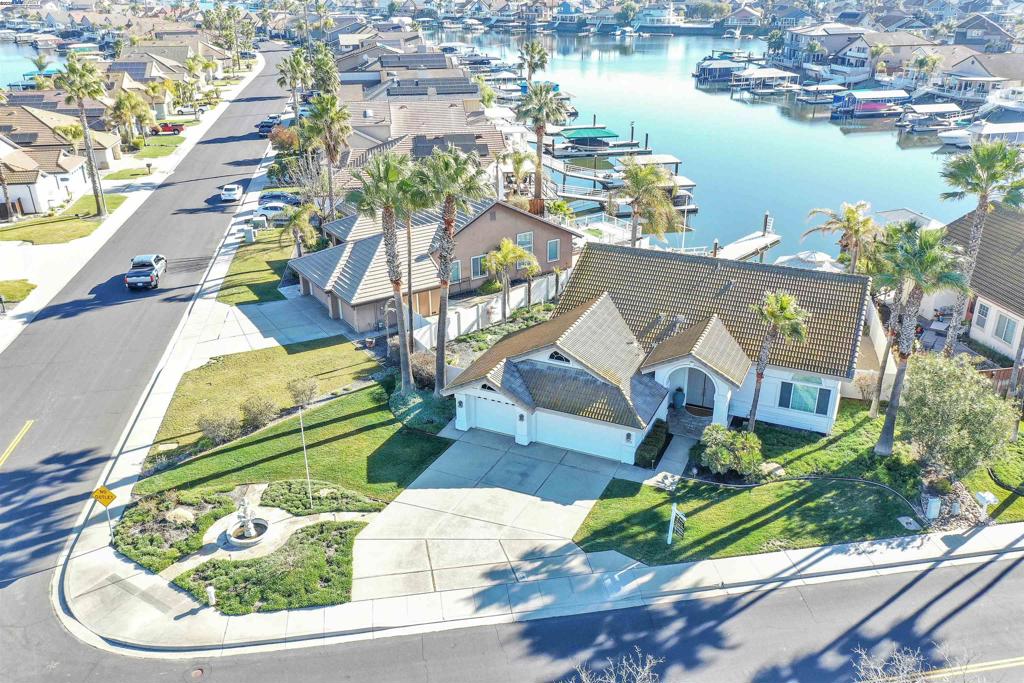 PRICED FOR QUICK SALE - MIRAMAR 1 WATERFRONT SINGLE STORY WITH FABULOUS WATER VIEWS! PRIME 10,200 PRIME CORNER LOT - DESIRABLE FLOOR PLAN - 2099 SQ FT W/3 BEDROOMS & 2 FULL BATHS -3 CAR GARAGE - ENTERTAINER'S BACK DECK + LAWN (RARE TO FIND) + CEMENT PATIO W/GAZEBO & BOAT DOCK - Open floor plan w/high ceilings throughout - Formal Living & Dining area - Spacious family room w/fireplace opens to kitchen - Chef's kitchen offers granite counters, abundance of cabinets, Center-Island, double ovens, gas stove, eat at bar + casual dining area all with water views - Primary w/double entry door, spa like bath with jetted tub, separate shower, dual vanity's, walk-in closet & slider door to back deck - Beautifully landscaped back & side yards w/Built In BBQ center, Gazebo has TV hook up - 40ft finger dock w/ability to add another finger to make L-dock - Whole house water softener system - Finished garage w/cabinets & work bench - All this and more...