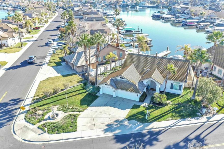 PRICED FOR QUICK SALE - MIRAMAR PLAN 1 - LIVE WHERE YOU PLAY - WATERFRONT SINGLE STORY WITH FABULOUS WATER VIEWS! PRIME 10,200 PRIME CORNER LOT - DESIRABLE FLOOR PLAN - 2099 SQ FT W/3 BEDROOMS & 2 FULL BATHS -3 CAR GARAGE - ENTERTAINER'S BACK DECK + LAWN (RARE TO FIND) + CEMENT PATIO W/GAZEBO & BOAT DOCK - Open floor plan w/high ceilings throughout - Formal Living & Dining area - Spacious family room w/fireplace opens to kitchen - Chef's kitchen offers granite counters, abundance of cabinets, Center-Island, double ovens, gas stove, eat at bar + casual dining area all with water views - Primary w/double entry door, spa like bath with jetted tub, separate shower, dual vanity's, walk-in closet & slider door to back deck - Beautifully landscaped back & side yards w/Built In BBQ center, Gazebo has TV hook up - 40ft finger dock w/ability to add another finger to make L-dock - Whole house water softener system - Finished garage w/cabinets & work bench - Enjoy boating, fishing and many restaurants on the water, Golf Course nearby - All this and more...