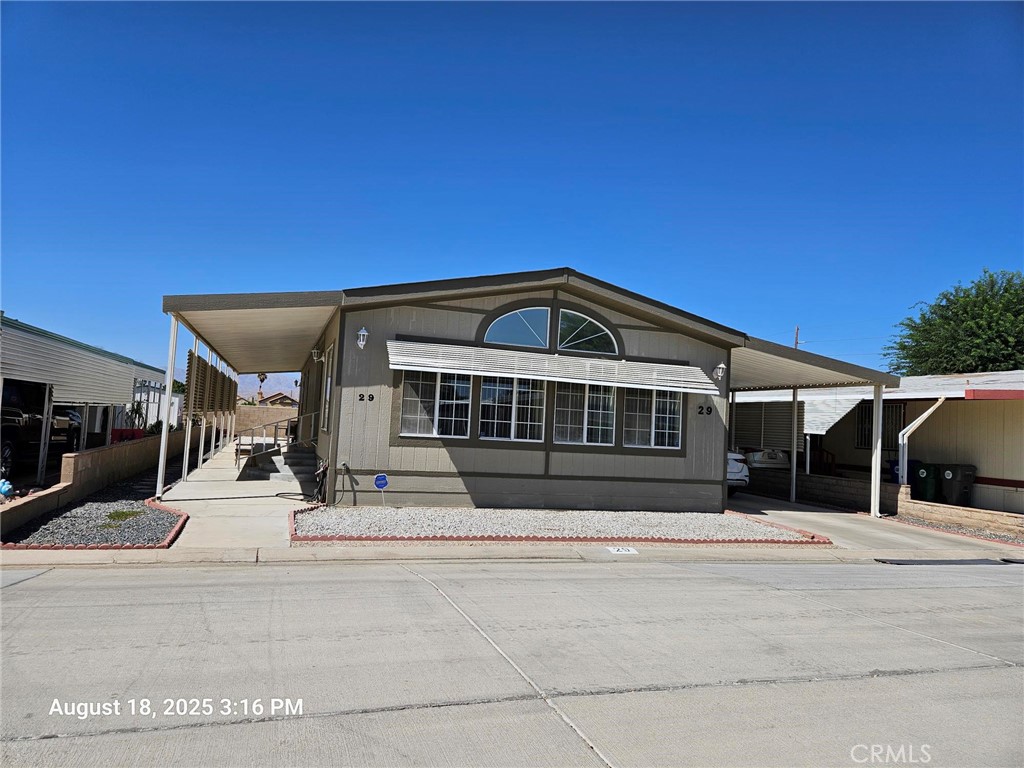 OWN THE LAND, ON TAX ROLL. 433A Certified. Welcome to your new home! Located in gated 55+ real manufactured home community of Rancho Carnitas featuring 2 bedrooms, 2 full bathrooms with a lot of spaces on both sides to park your car. As you enter the home, there is a great room to entertainment your guest and for yourself to relax. There is a built-in beautiful curio in the dining area, next to the spacious kitchen along with refrigerator, double oven and dishwasher. A large laundry room including the washer dryer is connected to the side yard where you can park your car and a big shed for your storage. A standard bedroom and 1 full bath in the hall. The master bedroom is spacious with walk-in closet and its bathroom has dual bathtub and shower. The house is surrounded with a low maintenance concrete and gravels. This low HOA community offers a host of amenities including a clubhouse for community gathering, a refreshing pool and spa to relax, a tennis court for exercise. Centrally located near stores, supermarket like Stater Bros, Food4Less, Wal-Mart and Costco of La Quinta. Come see to make it yours!