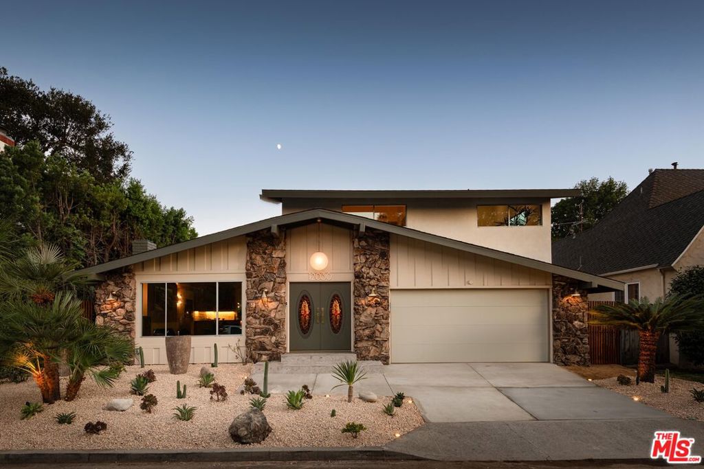 Tucked away on a quiet cul-de-sac in the heart of Studio City, this completely rebuilt Mid-Century Modern home blends timeless design with today's most refined upgrades. Taken down to the studs and reimagined with exacting attention to detail, it strikes the perfect balance between architectural integrity and modern innovation. A double-door entry opens to interiors wrapped in custom walnut millwork. The living room, anchored by a sleek electric fireplace and Samsung Frame TV, offers a warm gathering space for friends and family. Just beyond, the chef's kitchen features premium Jadore quartzite countertops, a curved custom island, Dacor appliances, and bespoke cabinetry. The kitchen flows seamlessly into the dining room, where pocket sliding doors open to the backyard and blur the lines between indoors and out. Upstairs, the primary suite includes a custom walk-in closet, an additional secondary closet, and a spa-inspired bath with dual vanities and a spacious shower. Two additional bedrooms share a thoughtfully designed full bathroom. A guest powder room is conveniently located on the main level. Outside, the private backyard is a retreat in itself, with a sparkling pool and spa surrounded by ample space for entertaining. Framed by a classic box gable roofline, the home honors its Mid-Century roots while embracing every modern comfort. Set within the award-winning Carpenter Community Charter district and just moments from Ventura Boulevard's shops and dining, this turn-key residence is a rare opportunity to own a true architectural gem in one of Studio City's most desirable neighborhoods.