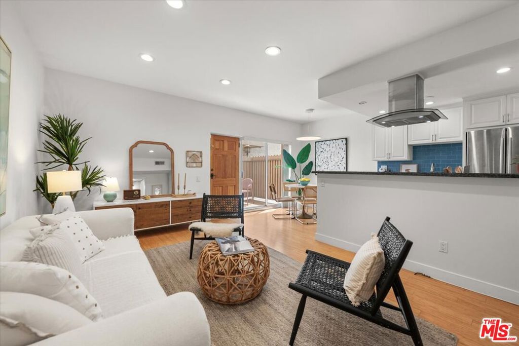 This light filled corner unit has a floor plan with only one shared wall and bamboo floors throughout. The updated open kitchen features granite counters, glass tile backsplash, stainless steel appliances, and a breakfast bar. West facing windows and a sliding glass door fill the home with natural light. The private patio opens directly to the pool and hot tub. The spacious primary suite includes two customized closets, one a walk in, which is a rare find. The spa inspired bathroom has stone tile and wood accents, a soaking tub, and a separate walk-in shower. Additional highlights include central heating/cooling and a tankless water heater. Building amenities include a gym, sauna, on site management, guest parking, and a secured garage with one dedicated space. Perfectly situated near UCLA, Brentwood Village, Barrington Park, Whole Foods, San Vicente Blvd, and some of the Westside's best dining and shopping, this condo offers an exceptional lifestyle in the heart of Brentwood.