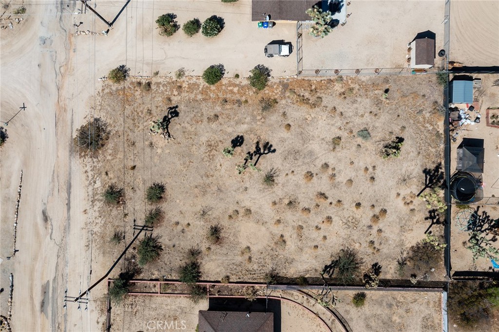 **See the Video Above!**
**Location! Location! Location!**
**VIEWS! VIEWS! VIEWS!**
Ready to build! Paid permits and plans include:
- Arborist Report and Tree Removal Permit
- Energy (T-24) Report
- Percolation Report
- Precise Grading Plan
- Site Plan
- Foundation Plan
- Framing Plan
- Floor Plan
- Roof Plan
- Reflected Ceiling Plan
- Structural Details and Calculations
This desirable location offers stunning views of both the mountains and the city, making it an ideal spot for a desert home or a short-term rental. It's conveniently close to town shops and amenities, and just a short drive to Joshua Tree National Park and Pioneertown attractions.
This sought-after location boasts stunning views of both the mountains and the city, making it an ideal spot for a desert home or a short-term rental. It is conveniently close to local shops and amenities and just a short drive from Joshua Tree National Park and Pioneertown attractions. Water is accessible from the street, and an electric pole is located near the property line.
Don't miss out on this desert gem! Build your home with a direct view of the magnificent Mount San Jacinto. The area features many high-end homes and is located near a golf course, with Palm Springs just a short drive away! Water is available in the street, and an electric pole is located near the property line.