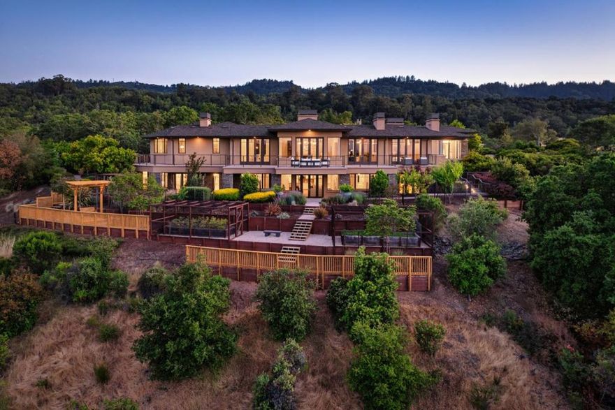 Prominently perched on the Portola Valley hillside, this contemporary home has been upgraded with the finest materials and craftsmanship providing glorious panoramic views of rolling hills with Silicon Valley and the Bay in the distance. This home is elegant, sophisticated and secluded and just a short drive to Silicon Valley with easy freeway access. The flexible floor plan includes six bedroom suites, dedicated office/den with fireplace, living room with soaring ceilings, fireplace, adjacent balcony and forever views, great room with access to the outdoor kitchen and spa plus a gathering spot and an in-home theater on the lower level. The kitchen is appointed with high-end appliances, butlers pantry, island and breakfast bar, all open to the casual dining/family room--perfect for intimate gatherings and sufficient for hosting formal dinner parties or large events. The garden boasts wrap around balconies and patios, views, beautiful plantings in front and sunny, enclosed fruit/vegetable beds below. Solar power system with robust Tesla battery support, 5 zone heat & A/C, full property security system, two laundry facilities, two two-car garages and community pool/spa complete this move-in ready home. Top rated Portola Valley schools. Close by hiking/biking/equestrian trails.