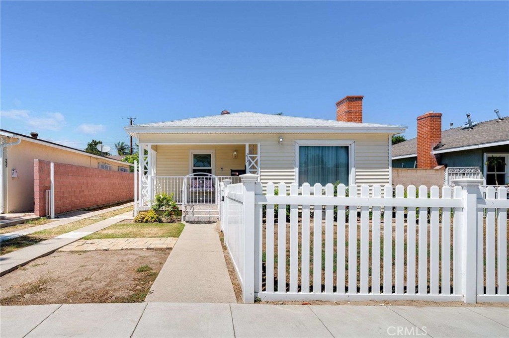 Welcome to this charming detached 2-bedroom, 1-bath home, perfect for comfortable living. Step onto the inviting covered front porch and take in the beautiful curb appeal, highlighted by easy-care vinyl siding and a long driveway that offers ample parking. Inside, you’ll find redone hardwood floors and tons of ambient light that create a warm, welcoming atmosphere throughout. The updated kitchen features natural wood cabinets and granite countertops, making meal prep a pleasure. The remodeled bath adds a modern touch, while the convenient mud room keeps your living spaces tidy. Enjoy plenty of storage and workspace with the one-car garage and attached workshop—ideal for hobbies or projects. This move-in-ready home combines functionality and style. With fresh interior paint, central air and heat, and a great backyard for entertaining. Close to several freeways, making commuting a breeze.