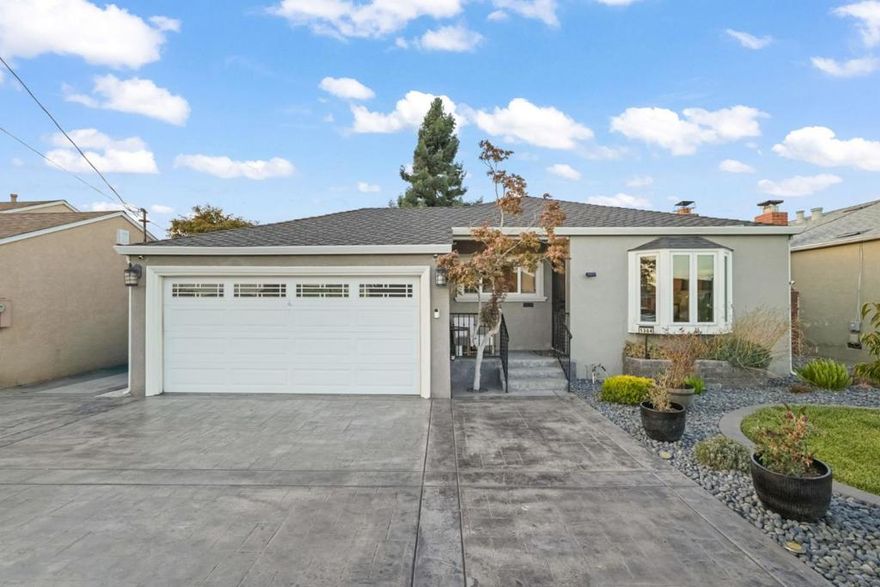 Welcome to 1364 Linton Street, a beautifully updated home in the heart of San Leandro that perfectly blends style, comfort, and convenience. From the moment you arrive, the homes curb appeal shines with a stamped concrete driveway, fresh landscaping, and a charming entry framed by lush greenery. Inside, sunlight pours in from the bay window, highlighting the spacious living area with hardwood floors, recessed lighting, and a classic fireplace that adds warmth and elegance. The layout flows into a spacious dining area, ideal for gatherings or family meals. The updated kitchen offers granite countertops, stainless steel appliances, warm wood cabinetry, and a skylit island that fills the space with natural light. Three well-appointed bedrooms provide restful retreats, and the modern bathroom features tasteful tile work and another skylight for an airy feel.  Not to be missed is the show stopping private backyard oasis with multiple seating areas, lush fruit trees & low-maintenance landscaping, perfect for relaxing or entertaining. With dual-pane windows, a finished garage, and thoughtful upgrades throughout, this move-in-ready home is close to shops, parks, schools & major freeways ideal for commuters and families alike.  Don't miss your chance to make this exceptional home yours!
