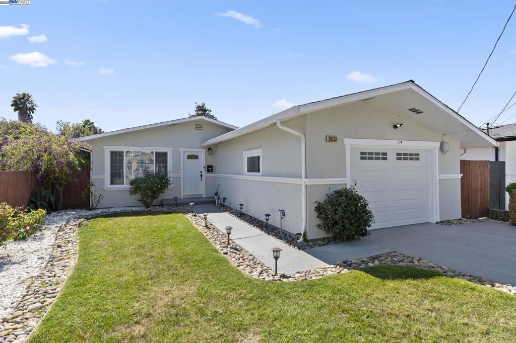 Welcome to this updated turn-key NE-facing 3-bed, 2-bath ranch-style home blending modern design with timeless comfort. The open, airy layout flows into a professionally landscaped backyard retreat. Curb appeal shines with lush lawn, river rock accents, and epoxy-coated walkway/driveway. Inside, a bright living room features a picture window, wood laminate flooring, and recessed lighting, connecting seamlessly to the kitchen/dining area. The kitchen boasts quartz countertops, stainless steel appliances (gas range, microwave, fridge), and reverse osmosis system, with backyard access from dining. Primary suite includes ensuite bath with decorative tile stall shower, dual shower heads, and custom door. Secondary bedrooms feature carpet and recessed lighting. Updated hall bath offers solid-surface vanity and shower/tub with custom tile surround. Backyard includes paver patio, turf, planter boxes, and accent lighting. Single-car garage offers epoxy floors, storage, laundry (W/D included). Other highlights: dual-pane windows, A/C, water softener, and custom window coverings. Convenient to parks, shopping, dining, BART, Tesla, Meta, and Silicon Valley.