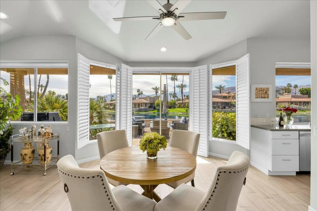 This exceptional Lake Mirage residence combines breathtaking southern mountain views with serene lakefront scenery. The highly sought-after St. Tropez floor plan is designed to highlight indoor and outdoor living, with the expansive living area, kitchen, and primary suite opening directly onto the lakeside patio. Recently refreshed, the home showcases dramatic beveled glass entry doors, ceramic plank tile flooring, an updated kitchen, a spa-inspired primary bath, a new air conditioner, an EV charger, and a new washer and dryer. Offered furnished per inventory, this refined retreat is completely move-in ready.The extended patio provides generous space for entertaining or relaxing while overlooking the water where resident swans swim gracefully by. A private dock is only steps away, inviting you to take out the included paddleboat and enjoy a peaceful ride across the lake or a short paddle to the nearest pool.Ranked among the top forty communities in the Coachella Valley, Lake Mirage offers a guard-gated sanctuary with seven tennis courts including six that are lighted, six pickleball courts, a fitness facility, and eleven pools and spas. A new cable TV/Internet package offers an amazing savings. Residents may also enjoy optional membership to the SCYA Yacht Club and an active social calendar. Perfectly located just moments from world-class dining, upscale shopping, Eisenhower Medical Center, and Palm Springs International Airport, this Rancho Mirage haven offers a rare blend of luxury, leisure, and convenience. The community is also recognized as a Certified Wildlife Habitat by the National Wildlife Federation.