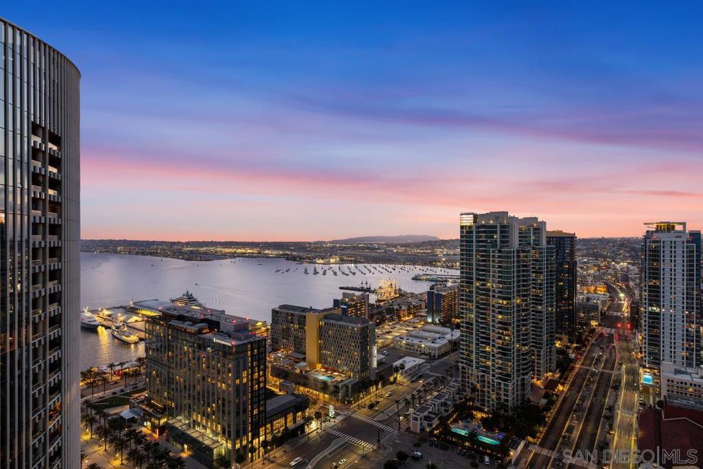 Behold your exclusive retreat, perched majestically on the 35th floor of the iconic Electra, high above San Diego’s vibrant heartbeat. This coveted northwest-corner residence unveils a sweeping panorama of the bay and city skyline, as though the horizon itself were framed just for you. Step inside—and be captivated by lustrous Cherry hardwood floors that flow beneath expansive windows, flooding every room with radiant daylight. A cozy fireplace infuses the space with soft warmth and an intimate ambiance. Two balconies beckon—the western terrace your private stage for nightly sunset dance over the bay. Culinary artistry awaits in your gourmet kitchen, outfitted with stainless-steel Bosch and Thermador appliances, polished granite counters, and a chic breakfast bar perfect for casual gatherings. Outside your front door, the excitement of downtown life is yours to embrace—just a short stroll to Waterfront Park, Seaport Village, and the eclectic energy of Little Italy. Here, luxury is not an afterthought—it is a way of life. A dedicated concierge attends to your needs, serene steam room, resort-style pool and spa, and fully equipped fitness center await your indulgence. On the tranquil 5th floor, Electra Park and BBQ terraces offer serene garden escapes amidst the urban hum with two parking spaces flanking a built-in EV charging station and a private storage. Ascend to new heights—experience life among the clouds in a residence that effortlessly elevates luxury and lifestyle into one sublime experience.