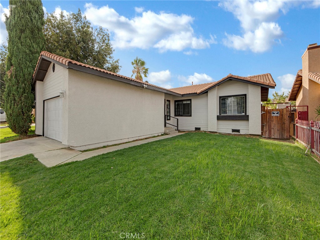 Welcome to this beautifully upgraded single-story home nestled within the desirable Park Shadows gated community in the heart of Palmdale. You'll love the quiet charm of this neighborhood and the prime location just across from community amenities—including a sparkling pool, park, playground, basketball court, and clubhouse. Step inside to a bright and airy open floorplan featuring vaulted ceilings, fresh laminate wood flooring throughout the main living areas, and plush new carpet in the bedrooms. The spacious living room welcomes you with a cozy fireplace and abundant natural light—perfect for relaxing or entertaining. The adjacent dining area opens to the backyard through a large sliding glass door, creating seamless indoor-outdoor flow. The kitchen has been tastefully updated with newer quartz countertops, stainless steel appliances, and ample cabinet space. The generously sized primary suite features vaulted ceilings and a private en-suite bathroom with dual sinks, while two additional bedrooms provide flexibility for family, guests, or a home office—one of which includes double doors that open to the living room, ideal for a den or workspace. Additional highlights include a newer HVAC system for year-round comfort, a two-car garage with laundry hook-ups, and a tile roof. The backyard is a blank canvas, ready for your personal touch to create the outdoor retreat of your dreams. This turnkey home is move-in ready and conveniently located near schools, shopping, and with quick freeway access. Don’t miss the opportunity to own this inviting and well-cared-for home in a gated community!