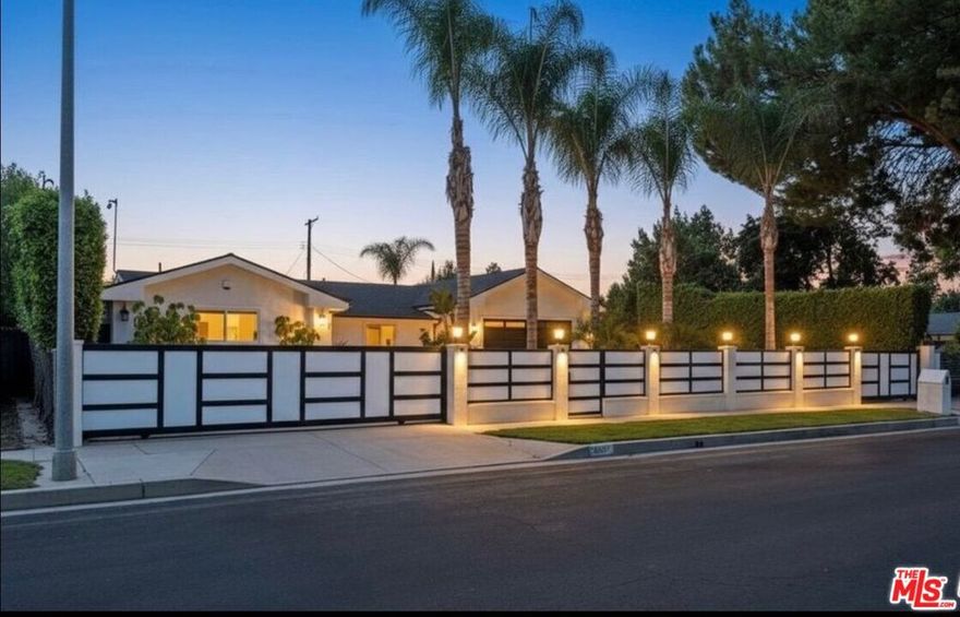 Set behind private gates, this beautifully designed single-story home offers a rare blend of privacy, functionality, and indoor-outdoor living in the heart of Woodland Hills. The residence features a spacious open layout with high ceilings, expansive living areas, and a contemporary kitchen equipped with an oversized island and stainless steel appliances, ideal for both everyday living and entertaining. The primary suite is thoughtfully separated and includes a walk-in closet, spa-style bathroom with soaking tub and steam shower, and direct access to the backyard. Three additional bedrooms provide flexibility for guests, office space, or family use. The outdoor setting is built for enjoyment, showcasing a heated in-ground pool, spa, fire pit, covered patio, and built-in barbecue area. Additional highlights include smart-home technology, surround sound, gated parking with circular driveway and RV access, and low-maintenance landscaping. Conveniently located near shopping, dining, parks, schools, and major routes. Available furnished at an additional cost, please inquire for details. Photos are Virtually Staged/Enhanced.