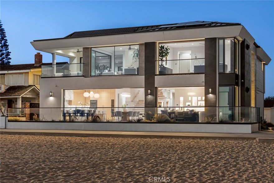 Commanding a rare double-lot along the pristine sands of Newport Beach, this newly completed architectural masterpiece stands as a statement of modern coastal luxury. With over 60 feet of coveted ocean frontage, the residence encompasses more than 4,400 square feet of meticulously composed interiors, complemented by expansive terraces that capture uninterrupted views of the Pacific. Every detail reflects a refined sensibility — soaring ceilings, limestone floors, and walls of glass that dissolve the boundary between inside and out. The primary suite is a sanctuary unto itself, offering a spa-inspired bath with infrared sauna, two state of the art walk in closets, and dual vanities. Designed for both relaxation and entertaining, the home features a chef’s kitchen appointed with Miele, Wolf, and Sub-Zero appliances, a bonus lounge with wet bar, a fitness studio overlooking the ocean, and a rooftop retreat with a full outdoor kitchen and panoramic vistas of the ocean and bay. A Boutique Luxury elevator, advanced smart home systems, solar integration with Tesla backup, and a climate-controlled three-car garage further distinguishes this exceptional estate. Poised on one of the most exclusive stretches of the California coastline, 706 W Oceanfront offers an unparalleled opportunity to embrace the quintessential Newport Beach lifestyle at the water’s edge.