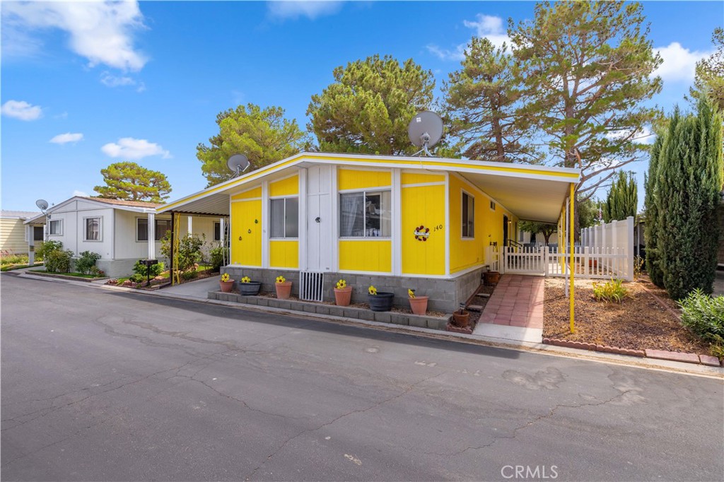 ***Take a look at the virtual floor plan and video tour of this lovely home!*** Enjoy the balance of a bright, cheerful exterior along with a crisp and neutral toned interior living space. This charming, 1983 built, double wide unit offers 1,440 sq. ft. of living space offers two living areas, two bedrooms, and two bathrooms. Upgrades that have been done within the last 2 years include new exterior paint, new swamp/evaporative cooler installed, new gas cooktop, and new wood laminate plank floors in the living areas and hallway. Enjoy low cooling costs with a newly serviced evaporative cooler, and for the winters stay cozy with central heat. Enjoy a short walk to the lake, which offers serene and peaceful views. The community also offers a library, recreational room, pool and spa for residents. The lake is open for paddle boats and fishing, and you may also encounter a friendly duck or goose there! Leisure Lake is private, gated, 55+ community located conveniently off the 14 freeway in Lancaster, CA. The park offers many community activities and is regarded by many as one of nicest 55+ parks in the Antelope Valley.