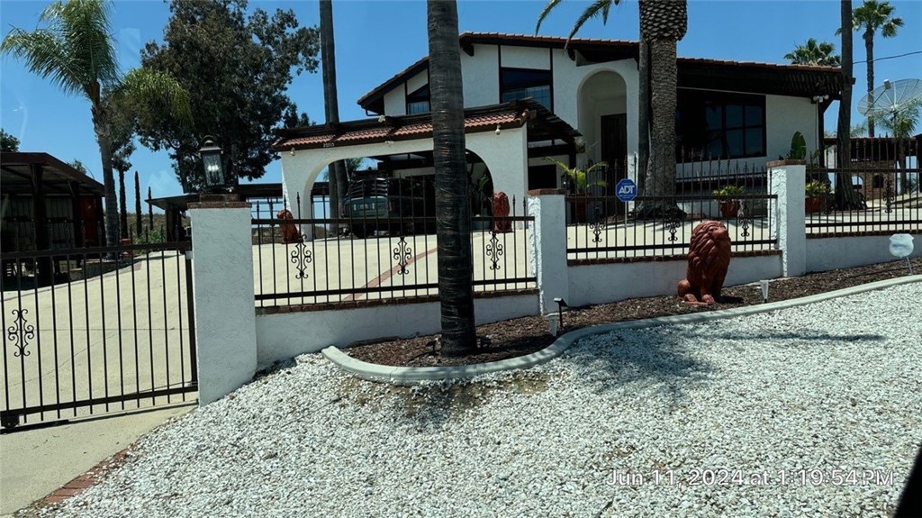 Newly Refurbished and fully furnished, resort like home, almost 3,000 sq. ft. of living space and sitting on a hill with views as far as eyes can see on almost four acres of land. Located in the much desired area of Lake Matthews Perris, Riverside County. Close to both Freeways 15 and 215, yet far removed enough for the serenity of a hill top residence overlooking the city of Riverside and views as far as Rialto, Fontana Ontario and the resort mountains. 4 bedrooms 3 baths, gorgeous pool. Bring your horses and all your other toys. Zoned for animals and located on a quiet cul-de sac. New kitchen, custom cabinets, custom wood floors. Fenced with remote control front gate. Olympic size pool, two car garage, four patios and beautiful palm trees. Plenty of space for RV parking, boat and other toys.