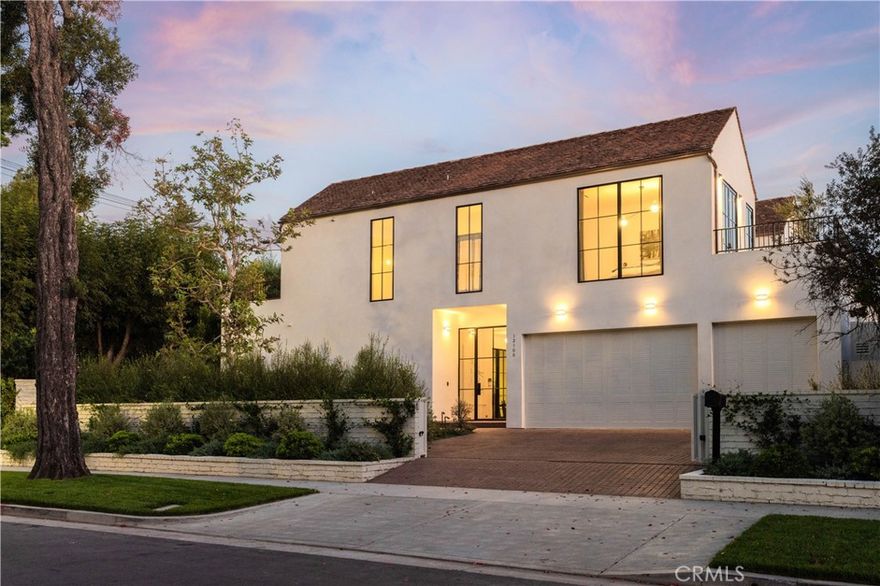 In the coveted Silver Triangle of Studio City, within the sought-after Carpenter School District, a rare architectural statement emerges—a home where craftsmanship and artistry merge into a singular vision of California living. Designed and built by Studio Rob Diaz, this newly constructed residence unfolds across 5,000 square feet on an 11,058 square foot lot, with 4 bedrooms, 4.5 baths, and an undeniable sense of presence. From the street, the orientation of shapes and textures hints at what lies within—an interplay of geometry and materiality executed with brilliance. A minimalist façade topped with Italian-imported terracotta roof tiles conceals an interior defined by warmth, restraint, and refinement. Inside, Belgian white oak floors and hand-finished Roman Clay walls soften the light that pours through soaring Euroline steel doors and floor-to-ceiling windows. Every surface is intentional, every line deliberate. Light itself is treated as art: Allied Maker pieces guide you through hallways, Roman & Williams illuminate the dining room and kitchen, Volker Haug accents the primary bedroom corridor, while the Apparatus Studio crowns the primary suite with sculptural fixtures above and in the spa-level bath. The chef’s kitchen is both centerpiece and sanctuary, anchored by Calacatta Paonazzo marble slabs, bespoke cabinetry, Spaces within hardware, Thermador appliances, a symphony of elegance and utility. The primary suite offers two private terraces, a spacious dressing room, and a bathroom where marble, dual showers, and a sculptural soaking tub invite ritual and repose. Additional amenities include a dedicated office, a wood-clad theater, Waterworks fixtures, integrated smart-home technology, Sonance in-wall speakers, EV charging, and solar panels. The exterior grounds mirror a private resort: a 50-foot black-bottom pool and spa stretch across cobblestone patios, while layered greenery and alfresco dining spaces deliver both seclusion and serenity. Perfectly positioned south of Ventura Boulevard, moments from Erewhon, The Shops at Sportsmen’s Lodge, Sugarfish, and the cafés of Tujunga Village, the home balances tranquility with accessibility. Outdoor lovers will appreciate Fryman Canyon nearby, while commuters benefit from swift access to the Westside, Hollywood, and Beverly Hills. The Hillslope estate is not just a home—it is a living composition of light, texture, and form that transforms everyday life into an experience of art.