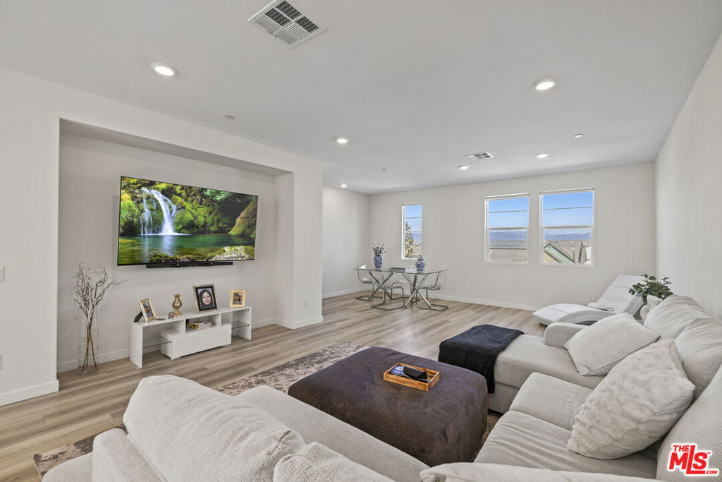 Welcome to your dream home at 27109 Valley Oak Place, a stunning 2022 construction that redefines modern luxury living, with modern amenities including multiple pools for both wading and lap swimming, spa, a community garden, recreation center, playground, barbecues, fire pit, and shaded lounge areas. This beautifully crafted three-story residence features three bedrooms and four bathrooms, offering 1,950 square feet of thoughtfully designed space. As you approach, you'll be greeted by a charming front courtyard, perfect for entertaining friends and family. The two-car garage provides ample room for your vehicles and extra storage. Enter to discover an expansive great room anchored by a spacious kitchen island, making it the ideal spot for family gatherings and entertaining. The gourmet kitchen is a chef's delight, featuring top-of-the-line appliances, elegant quartz countertops, and stylish shaker panel cabinets. Retreat to the luxurious primary suite on the third floor, where you'll enjoy privacy and comfort. The convenient laundry room is also located nearby, streamlining your daily routine. Situated in the heart of Valencia, the home is just moments to a variety of shopping, dining, and entertainment options. Experience a lifestyle of comfort, luxury, and convenience in this exceptional new construction home. Don't miss your chance to make this your own; schedule a showing today!