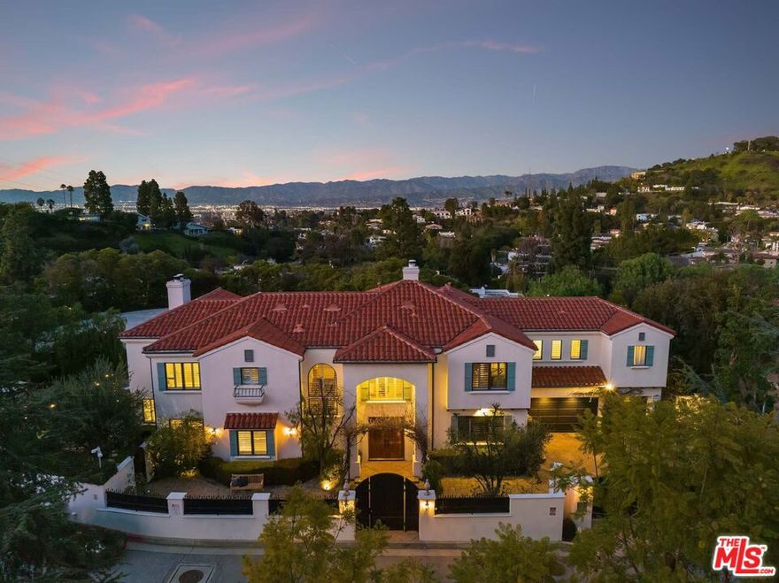 Situated on a private, gated cul-de-sac in the hills of Studio City sits this exclusive Spanish estate with a guest studio overlooking breathtaking canyon and city views. With over a half-acre lot, bask in the sun on expansive resort-like patios, lounge by the pool and spa, and entertain guests with the built-in BBQ and wood-burning fireplace amongst multiple grassy lawns. The spacious 5-bedroom home boasts an abundance of natural light, soaring ceilings, and custom details throughout. The recently remodeled gourmet kitchen features top-of-the-line appliances and breakfast area, with a separate formal dining room. A cinema quality theater and guest bedroom complete the first floor. The master suite is a true oasis, complete with a sitting area, fireplace, dual walk-in closets, and an oversized bathroom with a jacuzzi tub. The property also offers an attached guest studio with a separate entrance featuring its own kitchenette, bathroom, and walk-in closet. Three-car garage and walled courtyard offer ample parking and seclusion behind secured gates.