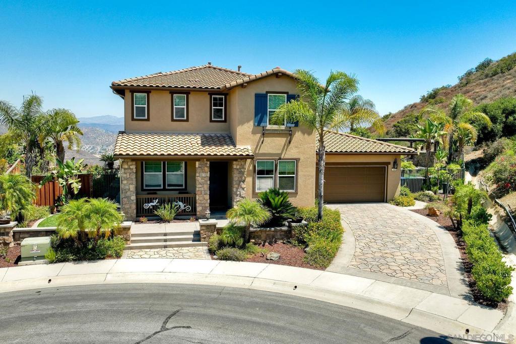 Discover Sky Ranch and the amazing views of this home in Santee. One of the best lots located at the end of a cul-de-sac with no homes directly below you. The backyard is perfect for entertaining or relaxing. The backyard features a built in bbq / fire pit, a raised patio with a water feature wall / firepit and a third firepit for watching the glowing sunsets. It also includes your very own putting green with lights for playing at night. The interior of the home features an open kitchen/family room. The dining room has custom cabinetry with a wine fridge. The primary bedroom has an en-suite bathroom and walk in, custom closet. Part of the 4 car garage has been turned into a walk-in pantry and additional cabinetry in the garage for storage. The solar panels have been paid in full. The Sky Ranch Community has a public park with bbq grills, open grass area and playground equipment. 7000 Mariposa is perfectly situated just minutes from everything Santee has to offer: Mission Trails Regional Park – ideal for hiking, biking, and nature lovers Santee Lakes Recreation Preserve – perfect for fishing, picnicking, and kayaking Trolley Square Shopping Center – with dining, shopping, and entertainment options Easy access to Highway 52 and 125, making commuting to downtown San Diego or the coast a breeze