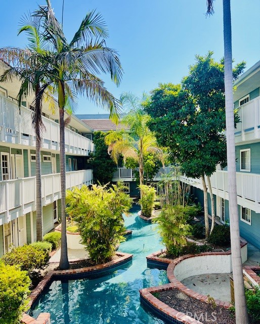 This Oasis condo will make you feel like you're on Hawaii, peaceful, tree-lined neighborhood near Madison Heights and the Playhouse District in Pasadena. Walking distance to cafe shops, Macy and Trader Joe's. Two blocks from Urth Cafe. This second floor unit is conveniently close to the elevator. As you step inside there is a cute little bar, the open floor plan immediately welcomes you with a bright and airy ambiance. To the left is the dining area provides a warm gathering space, and beyond it is the kitchen with windows overlooking the front hallway of the building and palm trees with blue sky. Flowing through from the dining area into the living room features high ceilings. Gorgeous big red brick fireplace and a large sliding glass window door leading to a spacious private balcony. To the right of the living room is a laundry room with double deck washer and dryer tucked away in a closet for convenience. The first bedroom is complete with two wall closets, providing plenty of storage, there is a bathroom diagonally to bedroom. The Left side of the condo is the Master bedroom with bath, it also has two closets with sliding doors lots of storage space. This home includes subterranean one parking with one small storage unit in front parking space.