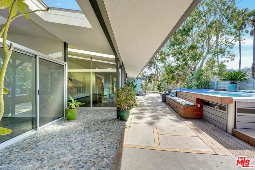 Timeless sleek charm! Explore the seamless blend of mid-century charm and modern allure at this Laurel Hills gem, located in the esteemed Wonderland School District in Laurel Canyon. Spanning 2,818 sq ft, this 4-bedroom, 3-bath beauty is an experience in architectural delight, updated kitchen and beautiful mosaic tiled bathrooms. This home is graced with expansive glass walls that invite floods of natural light. Revel in open spaces that flow effortlessly, creating a serene atmosphere perfect for both relaxation and entertainment. The property offers an above-ground swimmer's pool with soothing jets, nestled in a spacious yard, offering multiple entertaining areas. It's an ideal setting for gatherings, casual weekends, or quiet moments under the sky. This home stands on a flat walking street renowned as a famous trick-or-treat destination perfect for those seeking a vibrant, community-focused lifestyle.Rooms are bathed in natural light, and the clever design ensures an inviting warmth throughout. Here, you'll find not only a place to live but a place to live well, surrounded by lush landscapes and the welcoming embrace of a top-tier neighborhood.