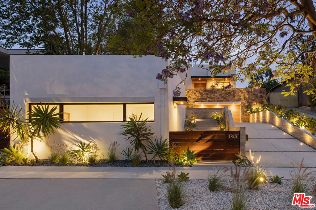 Live the dream in this modern Mykonos-inspired compound by SLVRLK Partners, a luxe retreat with a pool and ADU in prime Silver Lake. Silhouetted against iconic LA vistas of mountains and palms, the stunning home is dressed in stone and wood, delivering expansive volume and an open layout designed for day-to-night living, with skylit ceilings, wide-plank wood floors, and gorgeous light. Fleetwood doors connect to a multi-zoned backyard for basking by the pool and jacuzzi, lounging by the firepit, and aperitivo hour beneath the stars. Five bedrooms and seven baths offer endless options; a private balcony frames the Griffith Observatory and Hollywood sign, and a guest deck opens to views that reach the Pacific on a clear day. The ADU is a quiet escape with kitchen, bath, and rooftop deck taking in the DTLA skyline. Amenities include AC+heat, updated systems & built-in sound. Enjoy island-like privacy with Sunset's best just down the streetDayglow, Kamp, Night + Market Song, and more.