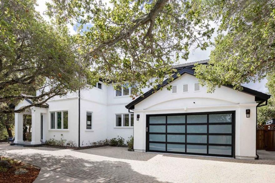 On a nearly third-acre oak-studded lot, this home blends warmth, sophistication, and expert craftsmanship with a wonderful sense of privacy. Inside, beautifully updated interiors feature hardwood floors, stylish fixtures, and a bright, open feel across two levels. The spacious living room shares a sleek two-way fireplace with the family room, while the formal dining room connects to the eat-in kitchen with its suite of Miele appliances. Five bedrooms include a convenient guest suite and an upstairs primary retreat with a spa-inspired bath. Multiple points open to the backyard, where a large patio, pool, and spa provide space for entertaining, and a serene koi pond creates a peaceful place to relax and reset, bringing a true sense of Zen to the setting. Though the location feels secluded, the home is just minutes from parks, the Emerald Lake Country Club, and downtown Redwood City, with access to acclaimed Roy Cloud Elementary and Woodside High (buyer to verify eligibility).