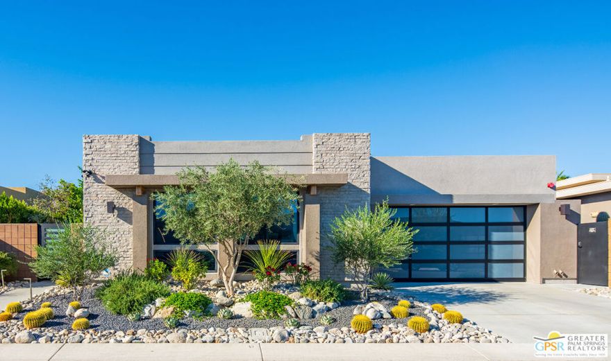 Step inside this striking Fiore model-an architectural single-story masterpiece tucked within the gated enclave of the renowned Escena Golf Club in Palm Springs. Offered furnished, Move right in.  Built in 2023 and custom-upgraded far beyond the builder's finish, this contemporary residence offers 3 bedrooms, 3 baths, and 2,593 sq ft of refined interior living space on a 6,970 sq ft lot. The open-concept great room welcomes you with soaring 17' ceilings, walls of glass, and panoramic views of two golf course fairways surrounded by the towering San Jacinto Mountains. Expansive sliders erase the boundary between indoors and out, filling the home with natural light and creating a seamless indoor-outdoor experience. Oversize porcelain tile pavers extend outward from the home interior, integrating both west and north facing outdoor entertainment areas, and creating a cohesive, spacious architectural flow that perfectly complements the exterior's extended desert landscape. At the heart of the home, the chef's kitchen blends beauty and performance with a 48" Fulgor Milano 7-burner induction range and double oven, JennAir Professional side-by-side built in refrigerator/freezer, microwave and 48" professional hood, SimPure reverse osmosis water filtration system, and oversized Calacatta quartz island. Every element was designed for entertaining and everyday luxury. The primary suite is a serene retreat featuring a spa-inspired bath with floating dual vanities, soaking tub and spacious walk-in shower offering accessibility from both sides. Two additional bedrooms with en-suite offer privacy and flexibility for guests, family, or a dedicated office. Step outside to your private sanctuary, where an in-floor system heated pool, electric pool cover, and mountain views invite relaxation at any hour. Owned-Solar, Tesla Powerwall, Hague WaterMax purification system, and LG mini-split air-conditioned garage further enhance the home's smart, sustainable design. The landscaping is a true work of art - professionally designed and upgraded with custom desert plantings, sculptural accents, and custom-designed entry gates that elevate the home's architecture and create a striking first impression. Every exterior element has been curated for low maintenance and maximum impact.  Within Escena, residents enjoy resort-style amenities including a championship golf course, scenic walking paths, a restaurant and bar - all just minutes from downtown Palm Springs dining, shopping, and festivals. 4321 Lumina Way is a masterclass in modern desert living - where sophisticated design, smart technology, and thoughtful upgrades combine to create an effortlessly elegant retreat.