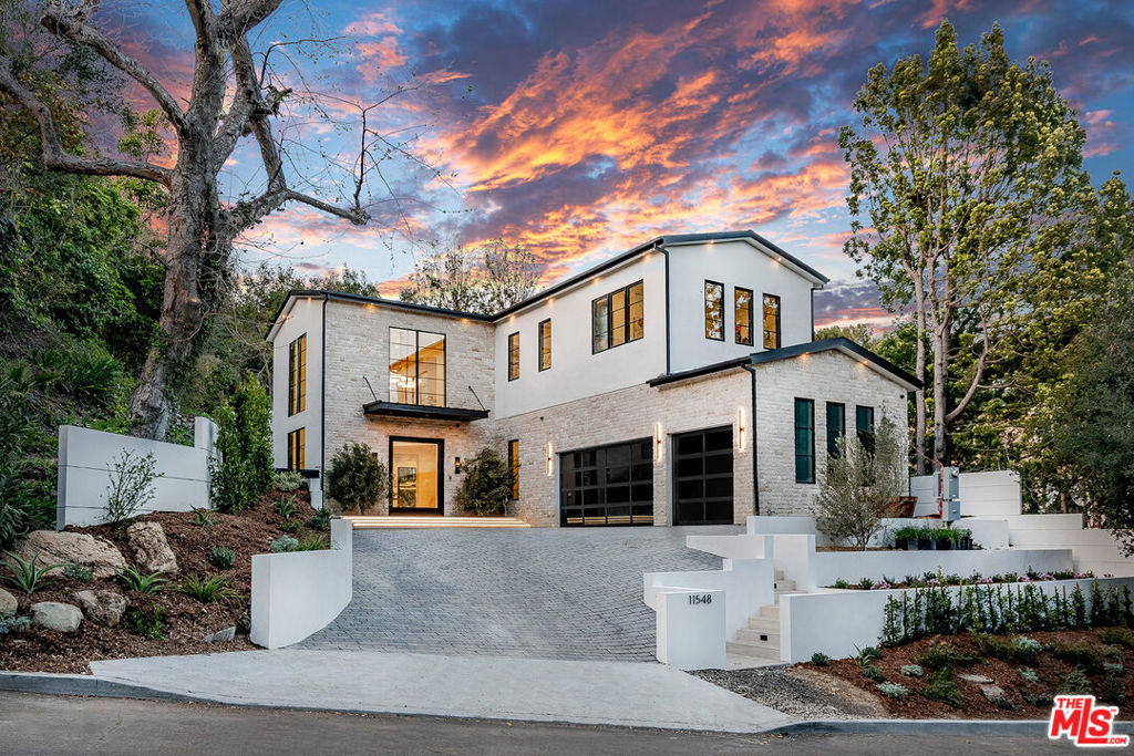 Nestled on a quiet and serene street in lower Bel Air, this brand-new construction Contemporary Farmhouse has been developed with the utmost attention to detail and the finest fixtures and finishes. Sited behind gates on an enormous 22,500 +/- SF lot, this smart home features every modern amenity imaginable on 2 living levels. A dramatic double-height entry foyer leads you to an open concept floor plan featuring 11 ft ceilings, walls of glass, and light oak hardwood flooring throughout. Luxury living spaces include a formal living room, dining room and butler's pantry connected to the chef's kitchen and contiguous family room with bar & wine display. The gourmet kitchen features Miele & Wolf appliances, pantry, oversized eat-in island, breakfast area, and custom millwork. Outfitted with a state of the art movie theater, office, and upstairs lounge/study room/gym, this architectural triumph is perfect for all lifestyle buyers and their discerning needs. 5 sumptuously appointed en-suite bedrooms feature spa-like bathrooms and custom closets. The primary suite features soaring pitched ceilings, private balcony, and dual closets, spa-like bathroom with steam shower & soaking tub. The bucolic grounds must be seen to be experienced, featuring various sitting areas, sparkling pool + 12 person spa, outdoor kitchen and bar, and a sprawling lawn - perfect for entertaining and enjoying the quintessential Southern California lifestyle.
