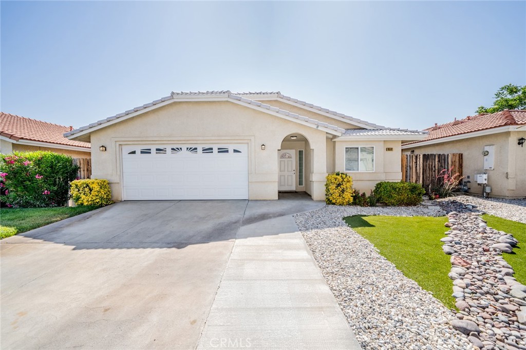 Welcome to your dream home nestled in a tranquil cul-de-sac, with 1,588 sqft of living space on a 4,386 sqft lot, this property is ideal for families seeking to live in a rural area, but not all the land to maintain. Step inside and be greeted by the inviting family room, a perfect gathering space highlighted by a cozy wood burning fireplace for those cool nights. The expansive kitchen/diner is a culinary enthusiast's delight, equipped with stainless steel appliances, new dishwasher and microwave, under sink instant hot water, tile floors that offer both style and easy maintenance. You will find a dedicated laundry room complete with cabinets leading seamlessly to a convenient 2-car garage. The home features three spacious bedrooms, all graced with new, plush carpeting. The master bedroom serves as a restful retreat, boasting an elegant master bathroom perfect for unwinding. One additional full bathroom provides ample space for family and guests alike. Outside, the property shines with a beautifully landscaped, low-maintenance front yard. The backyard is equally captivating, featuring a covered patio ideal for al fresco dining or enjoying peaceful evenings. It also hosts vibrant rose bushes, 2 cherry and 1 peach tree, adding touch of natural beauty. A fenced yard offers privacy and security, perfect for children and pets. Additional features include a leased solar system at $90 per month, ensuring energy efficiency, and a water softener that enhances water quality throughout the home. The Homeowners Association (HOA) covers water expenses for just $86 per month, making living both cost-effective and hassle-free. Convenience to local amenities. Make this home yours today!