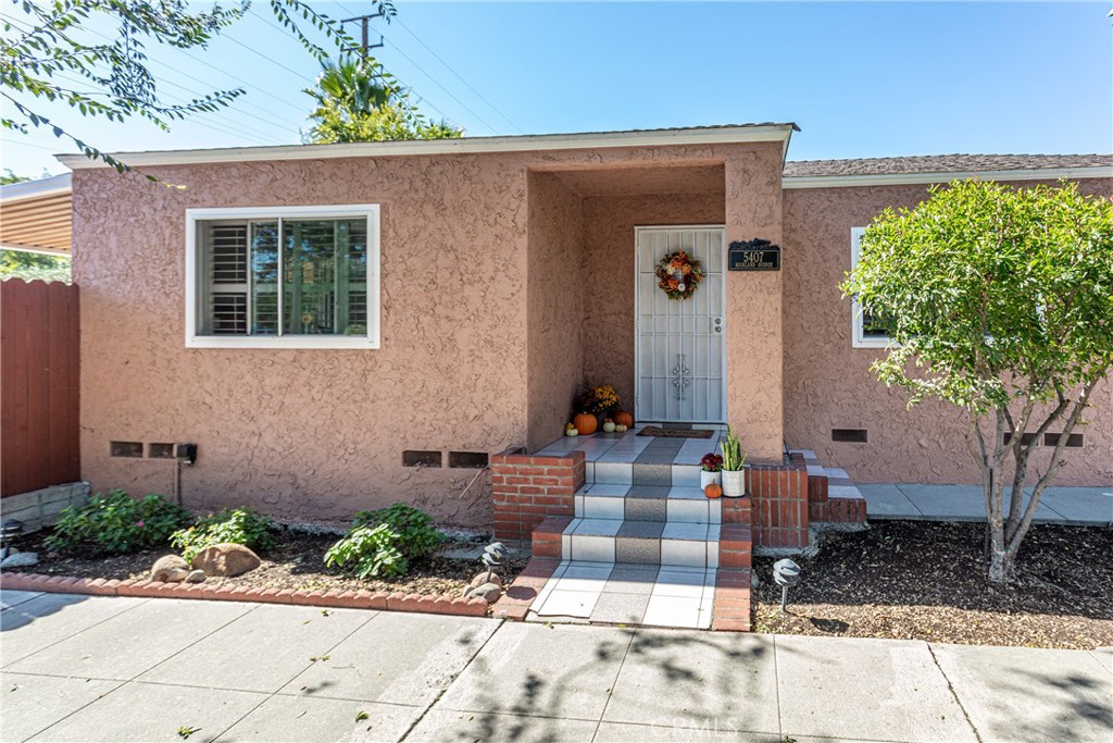 This impeccably maintained 3-bedroom, 1.75-bath home sits proudly on a corner lot across from the scenic Chandler Bike Path, blending comfort, style, and California charm. Step inside to discover rich wood floors, walnut-toned kitchen cabinetry, and stainless-steel appliances including a dishwasher and modern stainless sink all highlighted by natural light and elegant wood shutters on the windows. The spacious layout offers a seamless flow from the living area to the kitchen and outdoor spaces, ideal for first-time buyers or anyone seeking a move-in-ready home with timeless character. Outside, the property shines with thoughtful updates including beautifully stamped concrete with a brick ribbon detail, a covered patio, newer cement and paver work, and a private wooden fence surrounding a tranquil retreat complete with a hot tub and raised garden box. The one-car garage includes a washer and dryer, and the clever lot design enhances the home’s functionality and charm. Additional upgrades include a replaced sewer line to the street, dual-pane windows, fresh paint, mostly copper plumbing, and some electrical updates. Conveniently located near parks, shops, and dining, this home captures the best of North Hollywood living in one delightful package.