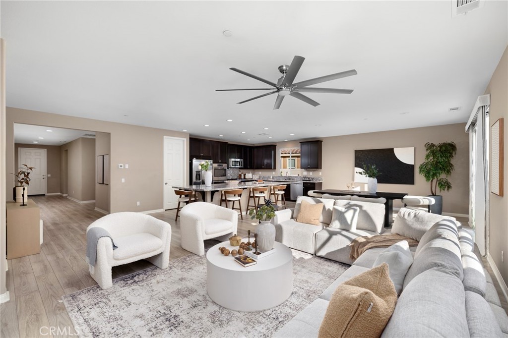 Located in the tranquil and peaceful community of The Ranch, 22677 Riverstone consists of 3 bedrooms, 3 bathrooms, and 2490 of living SF. Built in 2018 and sitting on an expansive lot of 7,871SF, this home is ideal for all types of buyers. Upon entering the home, guests will be greeted with a long elegant hallway, high ceilings, and upgraded flooring. A thoughtfully designed floor plan that consists of 2 large bedrooms that share a jack and jill bathroom ideal for a growing family or multi generational living. Transitioning down the foyer, a flex space can be utilized as an office, formal living room or dining room. The highlight of the home is the expansive open concept great/family room and kitchen that is well suited for hosting large gatherings and creating fond memories. The kitchen compromises of stainless steel appliances, designer grade counter tops, espresso cabinets that compliments the large island. The open flow seamlessly connects the kitchen to the adjacent dining area, making it ideal for daily living and entertaining. Retreat to the spacious primary suite designed for comfort and relaxation. The en suite bathroom offers dual vanities, a soaking tub, walk in shower, and is connected to a walk in closet. Thoughtful and countless upgrades have been done in and outside of the home. Lastly, enjoy a private, low-maintenance backyard designed for both relaxation and entertaining. Featuring a spacious artificial turf lawn, modern concrete stepping pads, and charming string lighting, this outdoor space is perfect for gatherings or quiet evenings at home. The fully fenced yard provides privacy while showcasing mountain views and palm trees, creating a serene setting with a touch of resort-style ambiance.